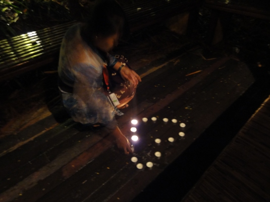 The Balinese waitress lighting up the candles